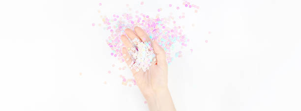 istock Pearl pastel confetti sparkles with woman hand 1167346148