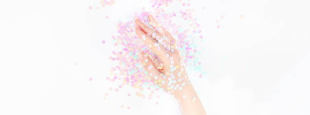 istock Pearl pastel confetti sparkles with woman hand 1167346163