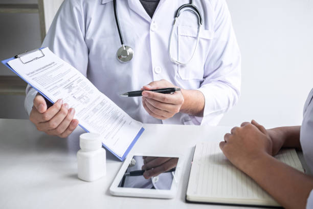 istock Doctor consulting with patient and checking sickness condition while presenting results diagnosis symptom examining about the problem of illness and recommend treatment method, Healthcare and medical 1167347122