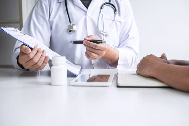 istock Doctor consulting with patient and checking sickness condition while presenting results diagnosis symptom examining about the problem of illness and recommend treatment method, Healthcare and medical 1167347133