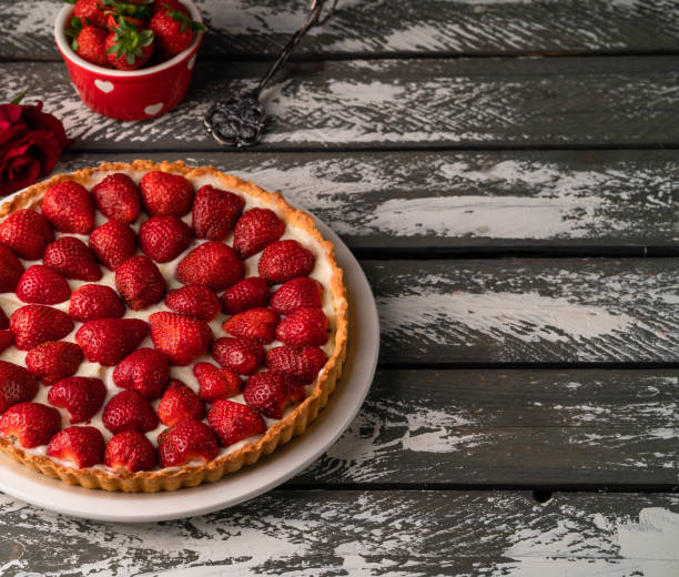 istock strawberry tart on wooden backdrop 1167348319