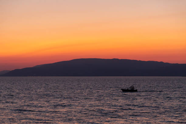 silhouette of a boat at sunset on Lake Iznik