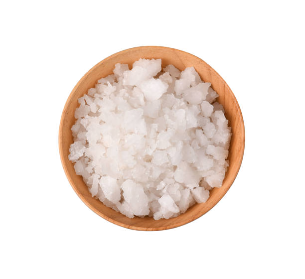 istock Top view salt in a wooden bowl isolated on white background 1167350174