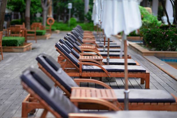 istock Reclining chairs by the pool in a luxury hotel 1167351345