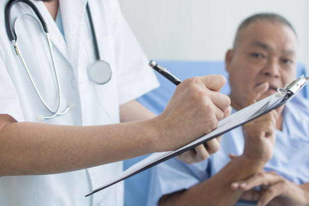 istock doctor asking and writing on sheet, patient interview and history taking 1167352801