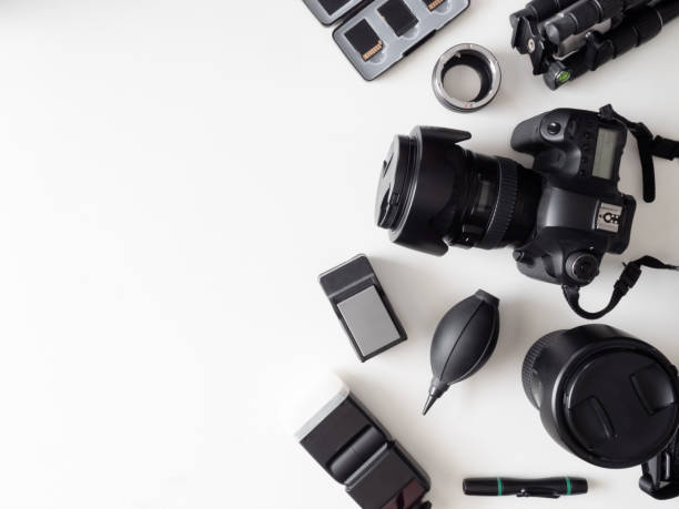 istock top view of work space photographer with digital camera, flash, cleaning kit, memory card, tripod and camera accessory on white table background 1167354101