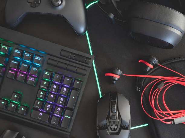 istock e-sport concept, top view a gaming gear, mouse, keyboard, joystick, headset, mobile joystick, in ear headphone and mouse pad on black table background. 1167354103