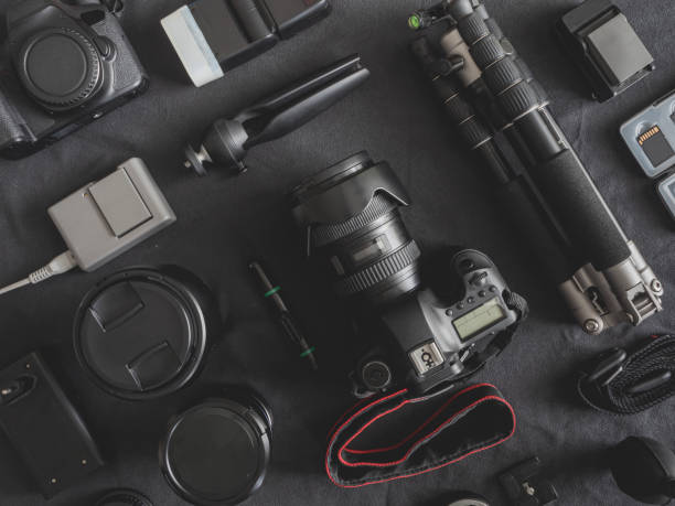 istock top view of work space photographer with digital camera, flash, cleaning kit, memory card, tripod and camera accessory on black table background 1167354107