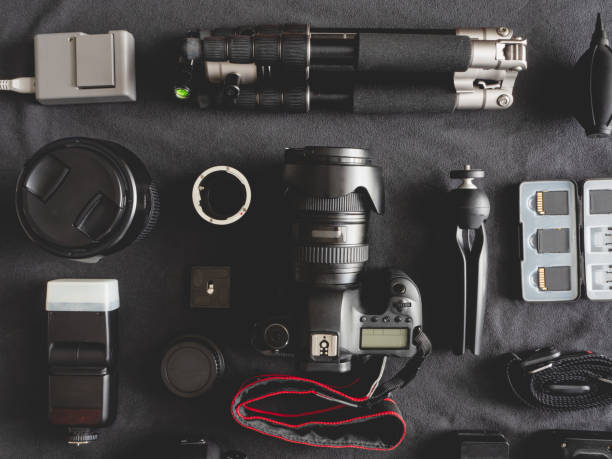 istock top view of work space photographer with digital camera, flash, cleaning kit, memory card, tripod and camera accessory on black table background 1167354151
