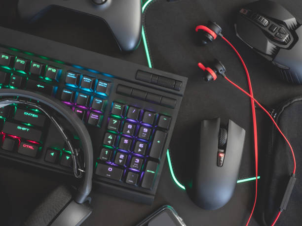 istock e-sport concept, top view a gaming gear, mouse, keyboard, joystick, headset, mobile joystick, in ear headphone and mouse pad on black table background. 1167354152
