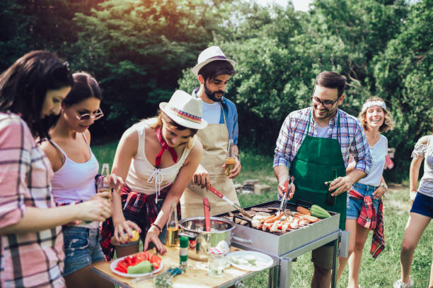 istock Young friends having fun grilling meat enjoying barbecue party. 1167355235