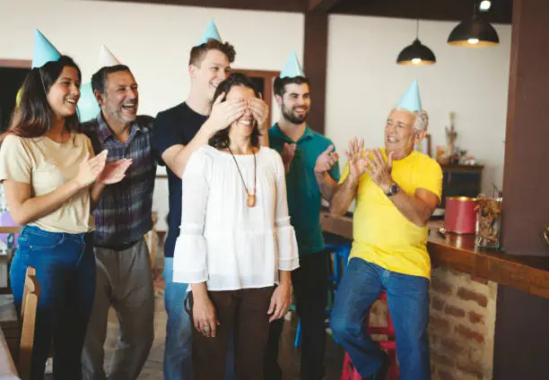 Family together preparing a surprise birthday party