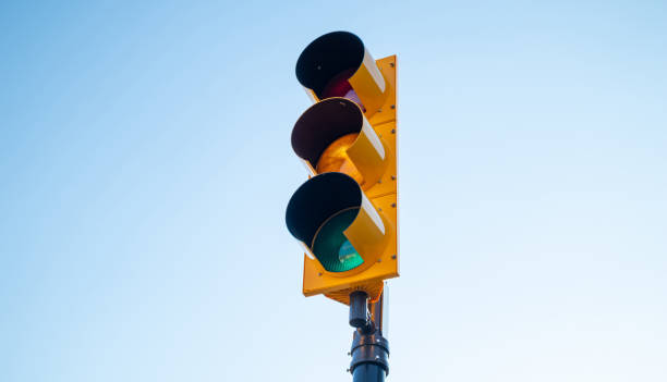 istock Green traffic light for cars, blue sky background 1167356239