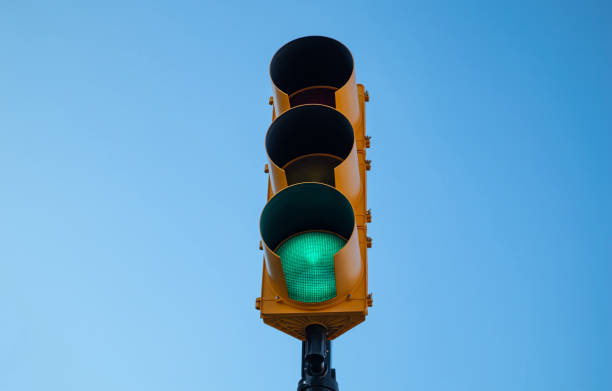 istock Green traffic light for cars, blue sky background 1167356677