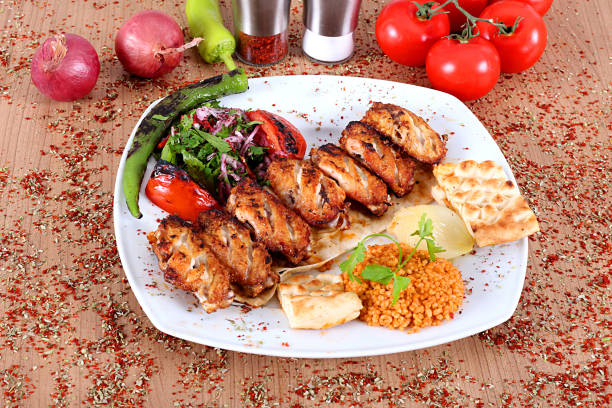 istock Roasted chicken wings served on a white plate with peppers onions 1167358365