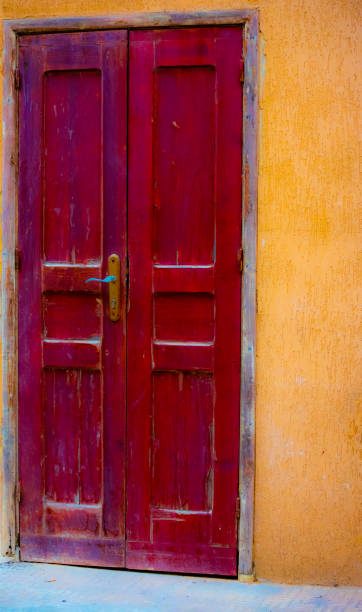 istock Red door and yellow wall 1167358511