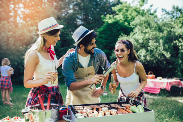 istock Young friends having fun grilling meat enjoying barbecue party. 1167361987