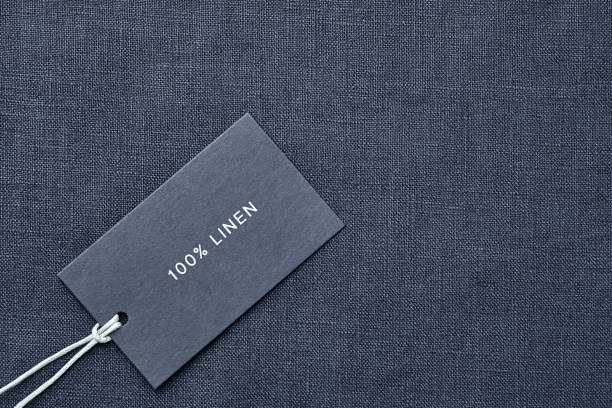 istock Label with composition of fabric on cloth background. 100% linen 1167362535