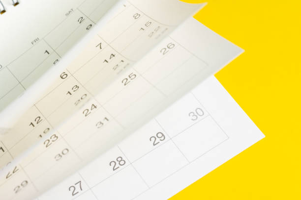 istock Time fly, season pass or reminder and appointment is coming event concept, white calendar turning pages with yellow background 1167366287