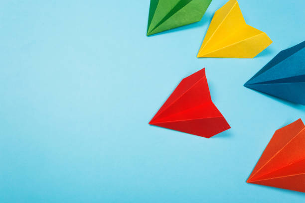 istock Color paper airplanes on blue background. top view 1167366436