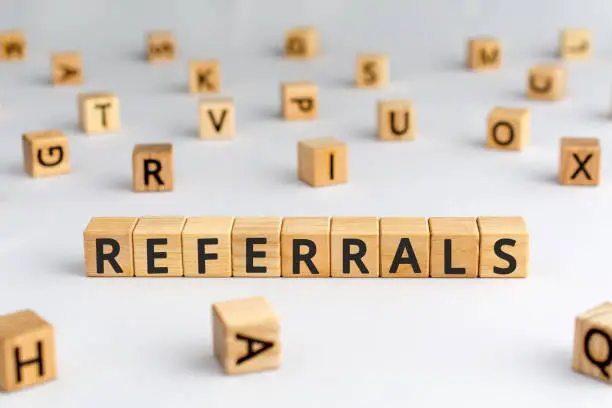 Photo of referrals - word from wooden blocks with letters