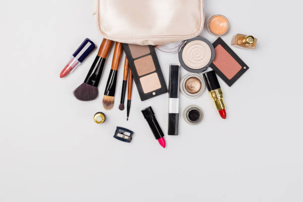 istock Makeup products with cosmetic bag and macaroons on light background 1167366721
