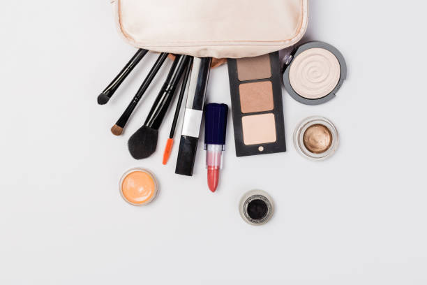 istock Makeup products with cosmetic bag and macaroons on light background 1167367422