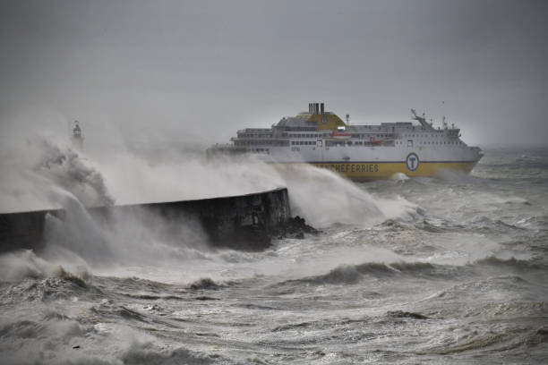 The cross English Channel DFDS Newhaven to Dieppe ferry departs Newhaven harbour for France into a raging storm at sea.