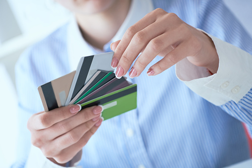 Woman hand holding various credit cards close-up.