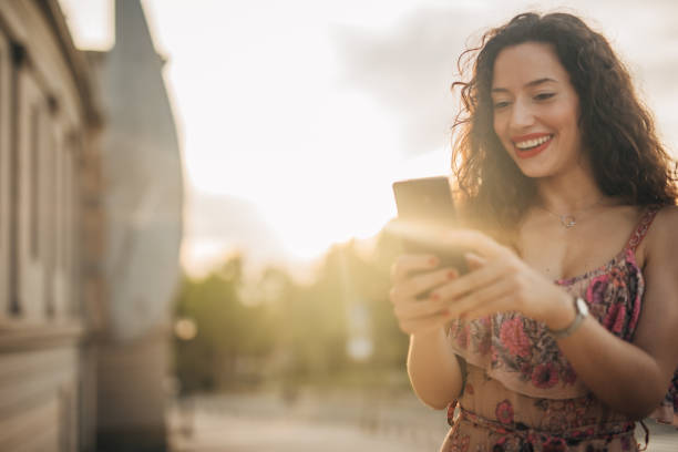 istock Woman using phone outdoors 1167377281
