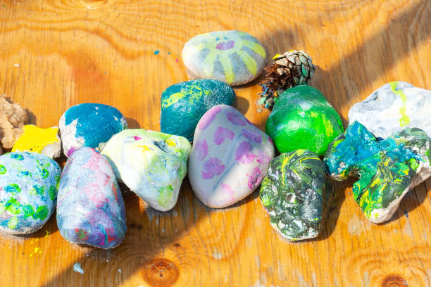 istock Beautiful multi-colored painted sea stones on a wooden table. Close-up. Backgrounds. 1167377541