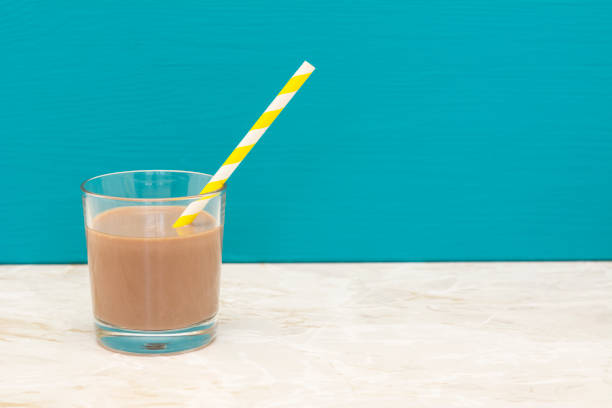 Chocolate milk glass with straw from above