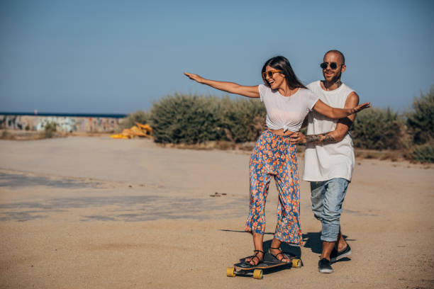 istock Couple having fun with skateboard 1167378515