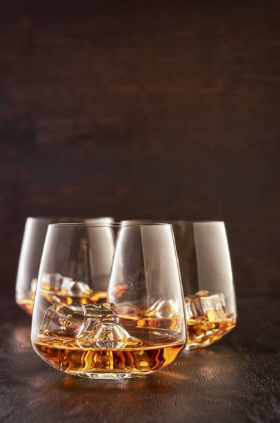 istock Crystal glass with whiskey on a wooden table 1167378591