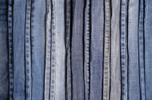 istock Denim. Blue jeans background. Stack of blue jeans different shadows 1167382854