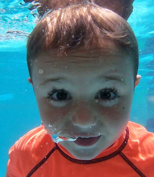 istock Boy in under water in the pool 1167383870