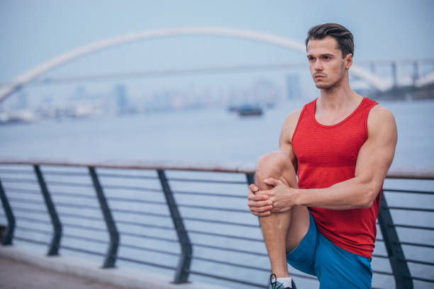 istock Handsome man exercising outdoors 1167385323