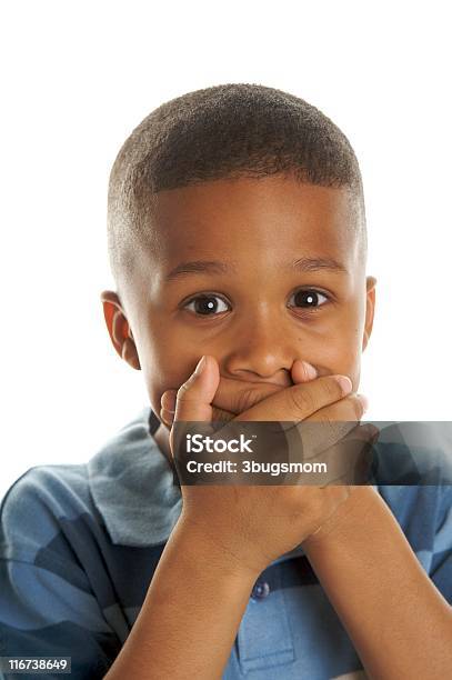 Cute Boy With Hands Over Mouth Stock Photo - Download Image Now - Hands Covering Mouth, Child, Human Face