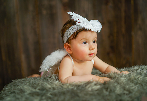 baby girl dressed in angel costume