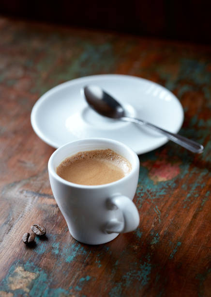 istock Cup of coffee and coffee beans on rustic wooden background. Copy space. 1167389773