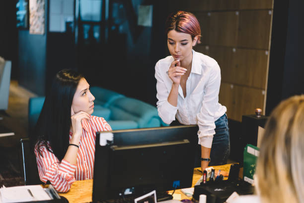istock Young attractive professional female employees pondering about startup project while collaborating in office.Contemplative skilled women implementing issues during brainstorming session indoors 1167389992