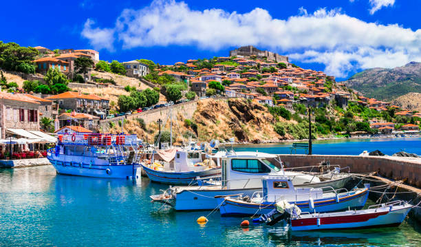 Best of Greece - scenic Lesvos island. Molyvos (Mythimna) town. view of port and medieval castle on hill top stock photo