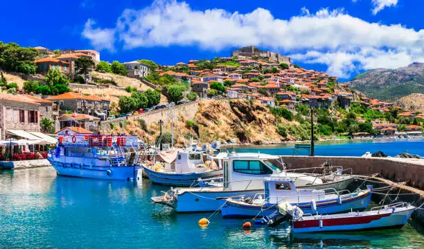 Photo of Best of Greece - scenic Lesvos island. Molyvos (Mythimna) town. view of port and medieval castle on hill top