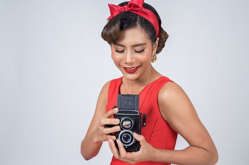 Happy fashion woman photographer hands holding retro vintage camera