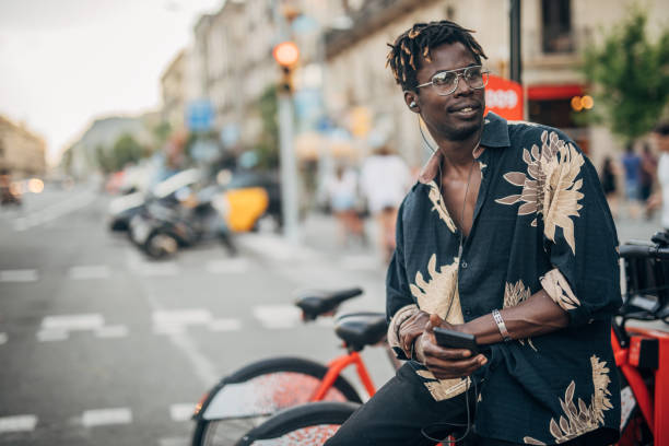 istock Man on the street using a smart phone with headphones 1167398332