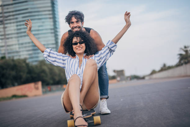 Man and woman skateboarding outdoors