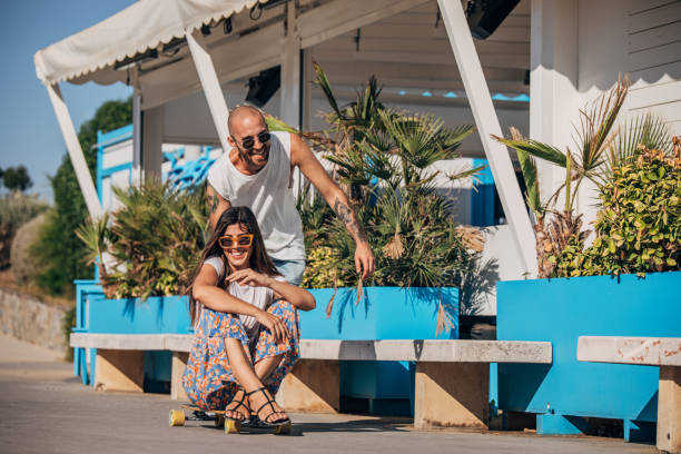 istock Couple having fun with skateboard 1167400935