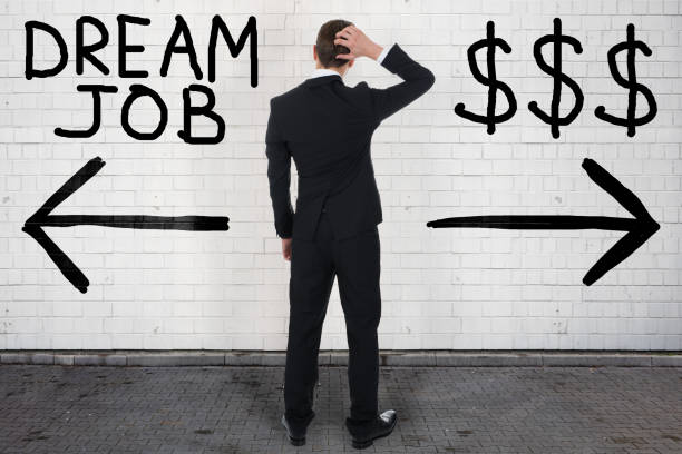 istock Confuse Businessman Choosing Between Dream Job And Dollar Sign 1167401469