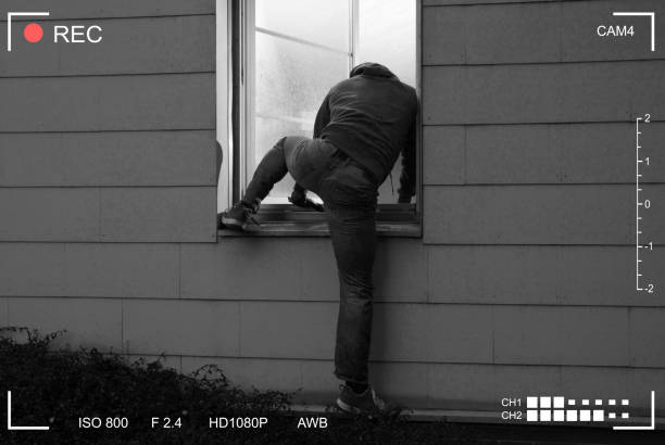 istock Burglar Entering House Through Window 1167402369
