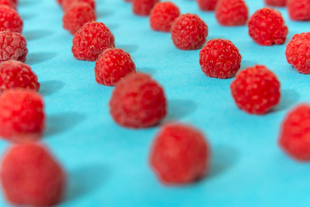 istock Colorful pattern of raspberries on blue background. Top view. Flat lay, pattern 1167402590